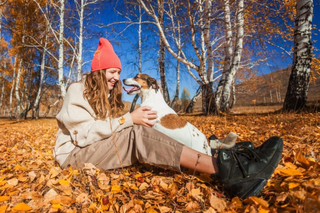happy-young-woman-with-dog-at-the-autumn-park-pretty-teen-girl-outdoor-at-fall.jpg